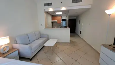 a living room with a couch and a kitchen at DRUVYA HOLIDAY HOMES, Marina Diamond 1, Close to Sobha Realty Metro 3 min walkable in Dubai