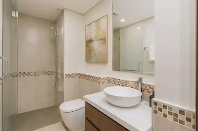 a bathroom with a sink and a toilet and a shower at Cosy 2BR Business Bay with Canal view and Swimming pool in Dubai