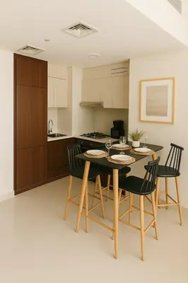 a kitchen and dining room with a table and chairs at Cosy 2BR Business Bay with Canal view and Swimming pool in Dubai