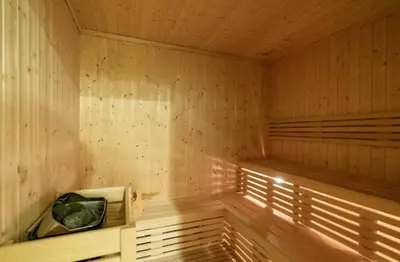 a wooden sauna with a bench in the middle at Cosy 2BR Business Bay with Canal view and Swimming pool in Dubai