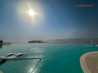 a swimming pool with a view of a body of water at Exclusive Home with Private Beach in Dubai