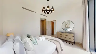 a white bedroom with a bed and a mirror at Vacationer l Urban Luxe 1 Bedroom l with Marina Views in Dubai