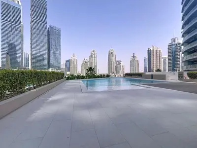 a swimming pool in the middle of a city with tall buildings at Vacationer l Urban Luxe 1 Bedroom l with Marina Views in Dubai