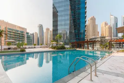 a swimming pool in a city with tall buildings at Vacationer l Bright 1 Bedroom l near Marina Promenade in Dubai