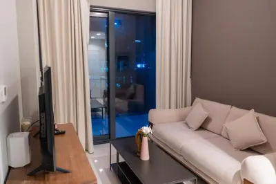 a living room with a white couch and a television at Stylish 1 BHK in Damac Zada Tower, Business Bay in Dubai