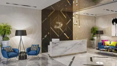 a lobby with two blue chairs and a marble wall at Stylish 1 BHK in Damac Zada Tower, Business Bay in Dubai