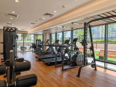 a gym with treadmills and elliptical machines at Stylish 1 BHK in Damac Zada Tower, Business Bay in Dubai