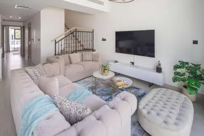 a living room with two couches and a flat screen tv at Frank Porter - Santorini 1, Damac Lagoons in Dubai