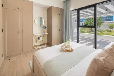 a bedroom with a large bed and a large window at Frank Porter - Santorini 1, Damac Lagoons in Dubai