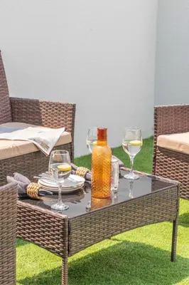 a table with two glasses and a bottle of wine at Frank Porter - Santorini 1, Damac Lagoons in Dubai