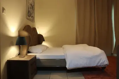a bedroom with two beds and a lamp on a table at Spacious 1 BR in Sulafa Tower in Dubai