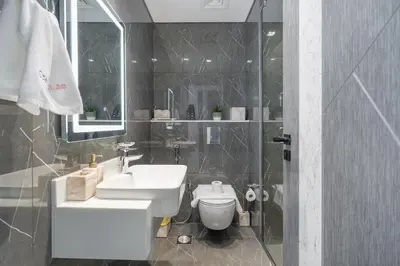a bathroom with a sink and a toilet and a shower at Elegant 2BR Apartment Private Pool by Czechin in Dubai