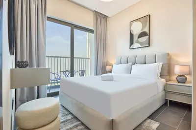 a bedroom with a large white bed and a balcony at STAY BY LATINEM Luxury 1BR Holiday Home CB1508 Near Burj Khalifa in Dubai