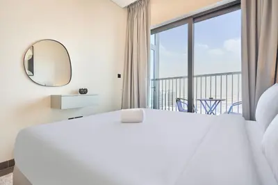 a bedroom with a large bed and a large window at STAY BY LATINEM Luxury 1BR Holiday Home CB1508 Near Burj Khalifa in Dubai