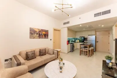 a living room with a couch and a table at Cosy 2 Bed Apartment in Al Jaddaf in Dubai