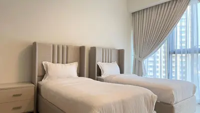 two beds in a room with a window at Premium 2bed Apartment In Downtown Act1 Tower in Dubai