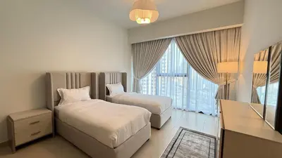 a hotel room with two beds and a window at Premium 2bed Apartment In Downtown Act1 Tower in Dubai