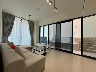 a large living room with a couch and a television at Binghatti Amber in Dubai