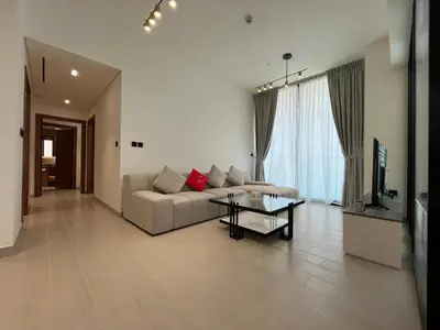 a living room with a couch and a table at Binghatti Amber in Dubai