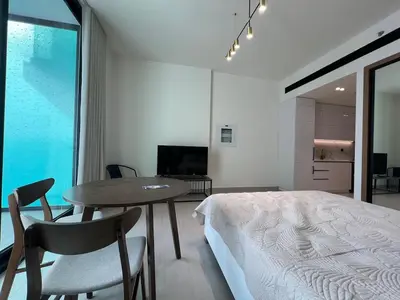 a bedroom with a bed and a table with chairs at Binghatti Lavender in Dubai