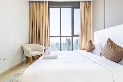a hotel room with a bed and a window at Superhost- Elegant Downtown 3BR , Burj Khalifa View in Dubai
