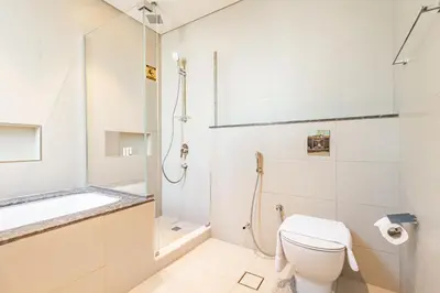 a bathroom with a toilet and a shower at Superhost- Elegant Downtown 3BR , Burj Khalifa View in Dubai