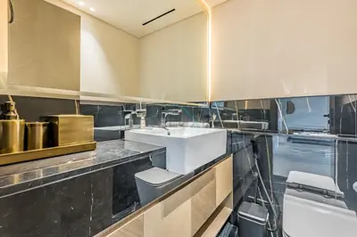 a kitchen with a sink and a counter at Trendy 1BR with a Glimpse of Burj Khalifa, Near Zabeel Stadium, Minutes Drive to Dubai Frame, Binghatti Creek, Al Jaddaf by Deluxe Holiday Homes in Dubai