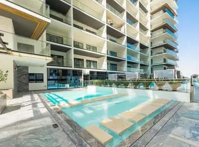 a swimming pool in front of a building at Trendy 1BR with a Glimpse of Burj Khalifa, Near Zabeel Stadium, Minutes Drive to Dubai Frame, Binghatti Creek, Al Jaddaf by Deluxe Holiday Homes in Dubai