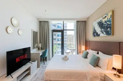 a hotel room with a large bed and a tv at Palm Jumeirah, panoramic free pool,beach in Dubai