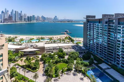 an aerial view of a resort with a beach and buildings at Palm Jumeirah, panoramic free pool,beach in Dubai