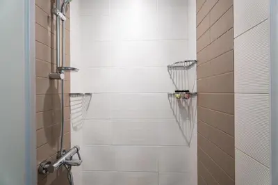 a bathroom with a shower stall with a basketball at GuestReady - Prime Location Stay | Business Bay in Dubai