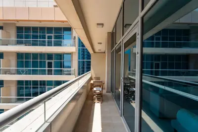 an empty corridor of a building with windows at GuestReady - Prime Location Stay | Business Bay in Dubai