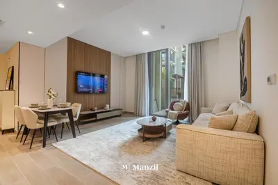 a living room with a couch and a table at Waterfront 1BR Apartment in Creek Harbour near Downtown in Dubai