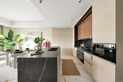 a kitchen with a black and white counter top at FIRST CLASS VILLA Hidden Luxury Gem in Dubai
