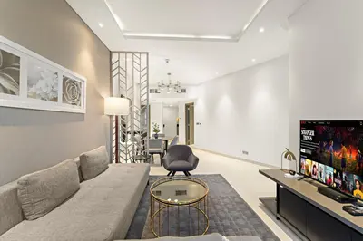 a living room with a couch and a table at Spacious 1BR with Balcony and Pool Access in Dubai