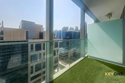 an office building with a view of the city at Majestine Living Stylish Studio with Canal View in Dubai