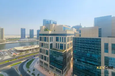 an aerial view of a tall building in a city at Majestine Living Stylish Studio with Canal View in Dubai