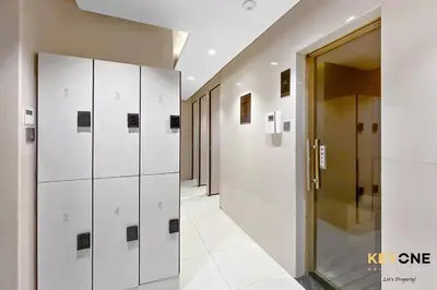 a hallway with white lockers in a building at Majestine Living Stylish Studio with Canal View in Dubai