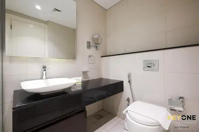 a bathroom with a sink and a toilet at Majestine Living Stylish Studio with Canal View in Dubai