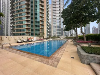 a swimming pool in a city with tall buildings at FIRST CLASS 2BR Luxe & Lively Living in Dubai