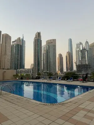 a large swimming pool in front of a city skyline at Marina Walk View Luxury 1BR close to JBR beach! in Dubai