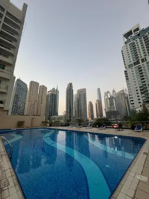 a large blue swimming pool in the middle of a city at Marina Walk View Luxury 1BR close to JBR beach! in Dubai