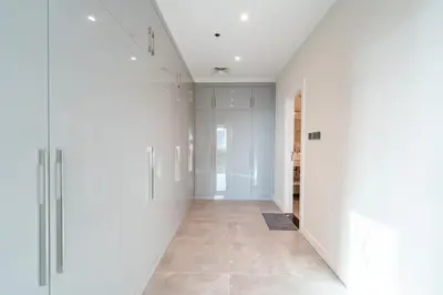 an empty hallway with white walls and a tile floor at Private Marina 5 Master Bedrooms & Private Pool in Dubai