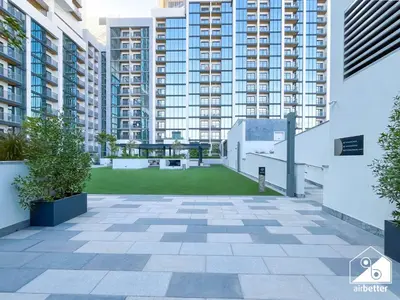 a courtyard in a building with tall buildings at Luxury 1-Bed in Meydan with Balcony & City Views in Dubai