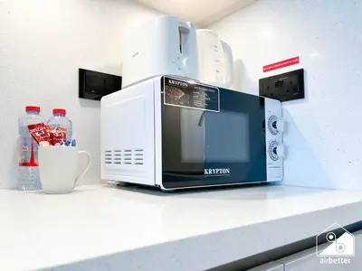 a microwave sitting on top of a counter at Luxury 1-Bed in Meydan with Balcony & City Views in Dubai