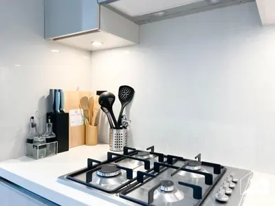 a kitchen counter with a stove top in a kitchen at Modern 1B Luxury , Scenic City Balcony, Pool & Gym in Dubai