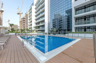 a swimming pool in a building with tall buildings at Vibrant Studio Your Perfect Stay Awaits in Dubai