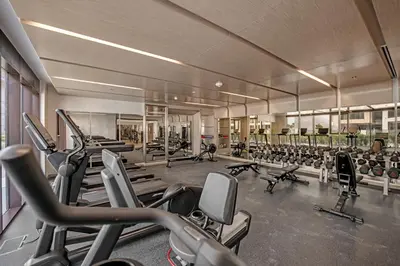 a gym with a lot of treadmills and machines at Vibrant Studio Your Perfect Stay Awaits in Dubai