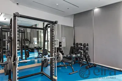 a gym with several treadmills and weights at Stylish 1 bedroom in Pinnacle, Dubai Hills in Dubai