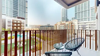 two chairs on a balcony with a view of a city at Vacationer l Upgraded 1 Bedroom l near Circle Mall in Dubai
